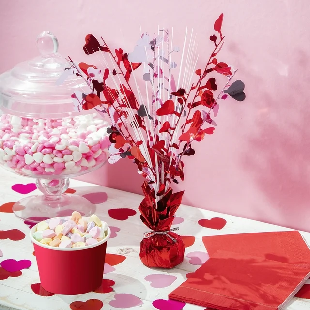 heart shaped confetti on valentines day table with candy